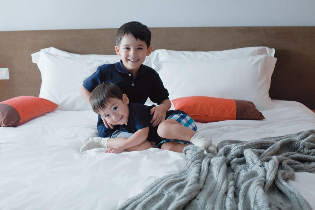 Fraser Place Robertson Walk Singapore Exterior photo Two children playing on a bed